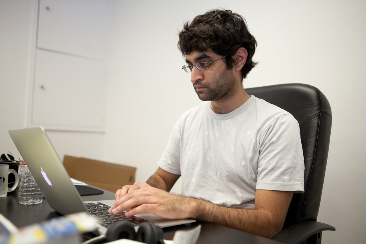 Exeter graduate Kush Patel in front of a computer