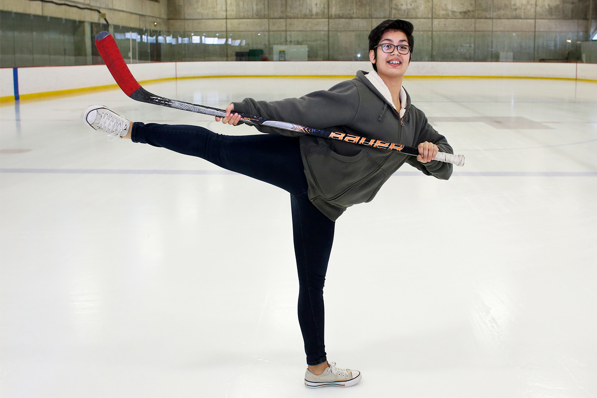 Fiona in a ballet pose with hockey stick.