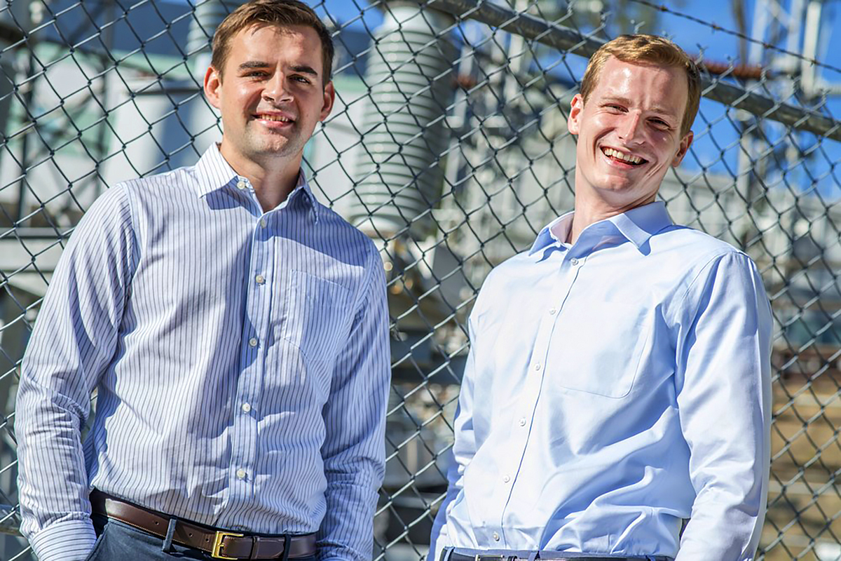 Jared with a former business partner in front a power plamt.