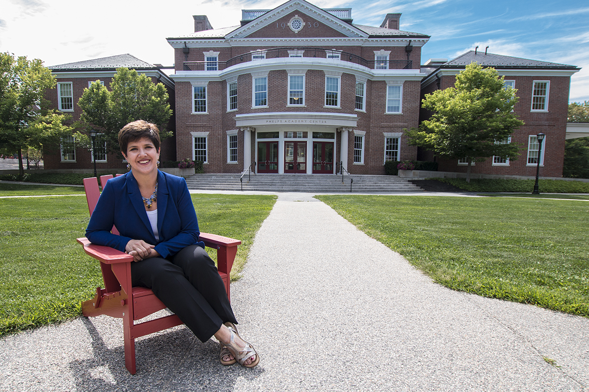 Joanne Lembo sitting outside in front of the Academy Center.