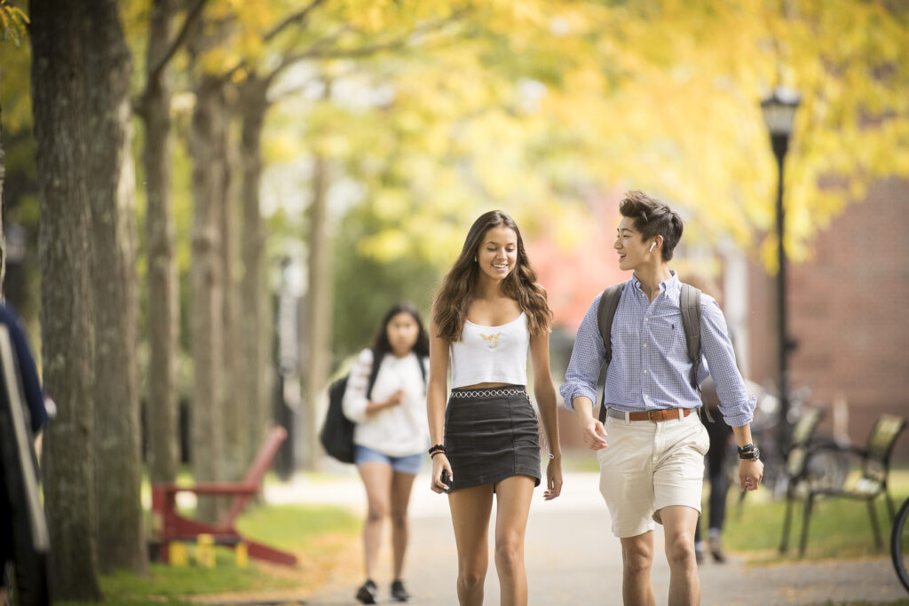 Boy and girl walking down path on campus.