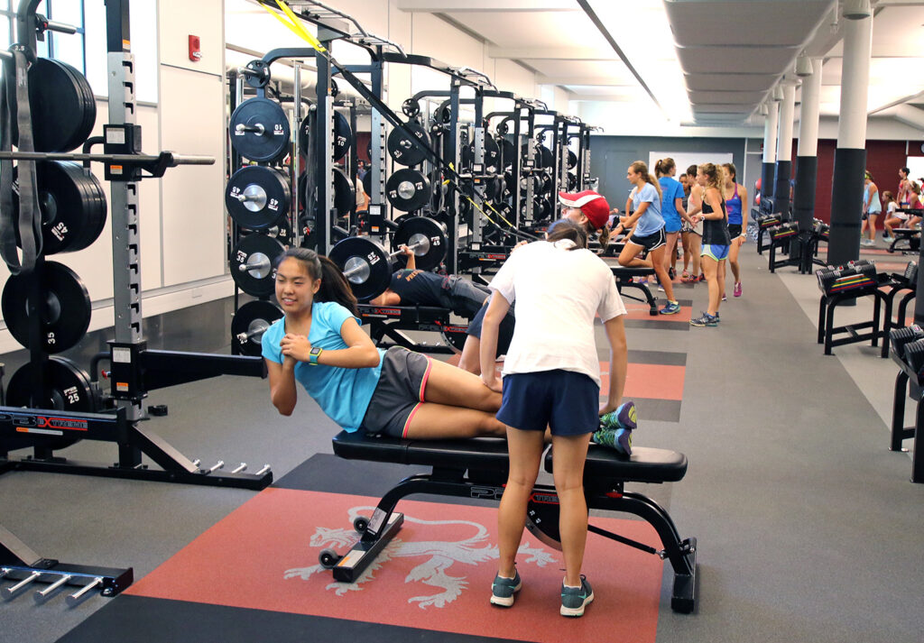 Two students using equipment in Downer Family Fitness Center