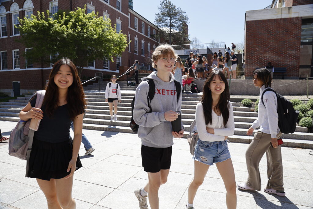 students walk across campus quad.