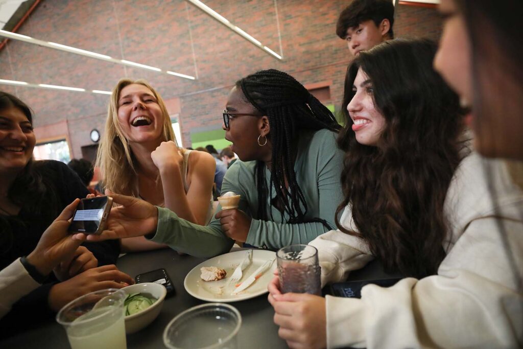 Group of students sitting at a table in Dining Hall.