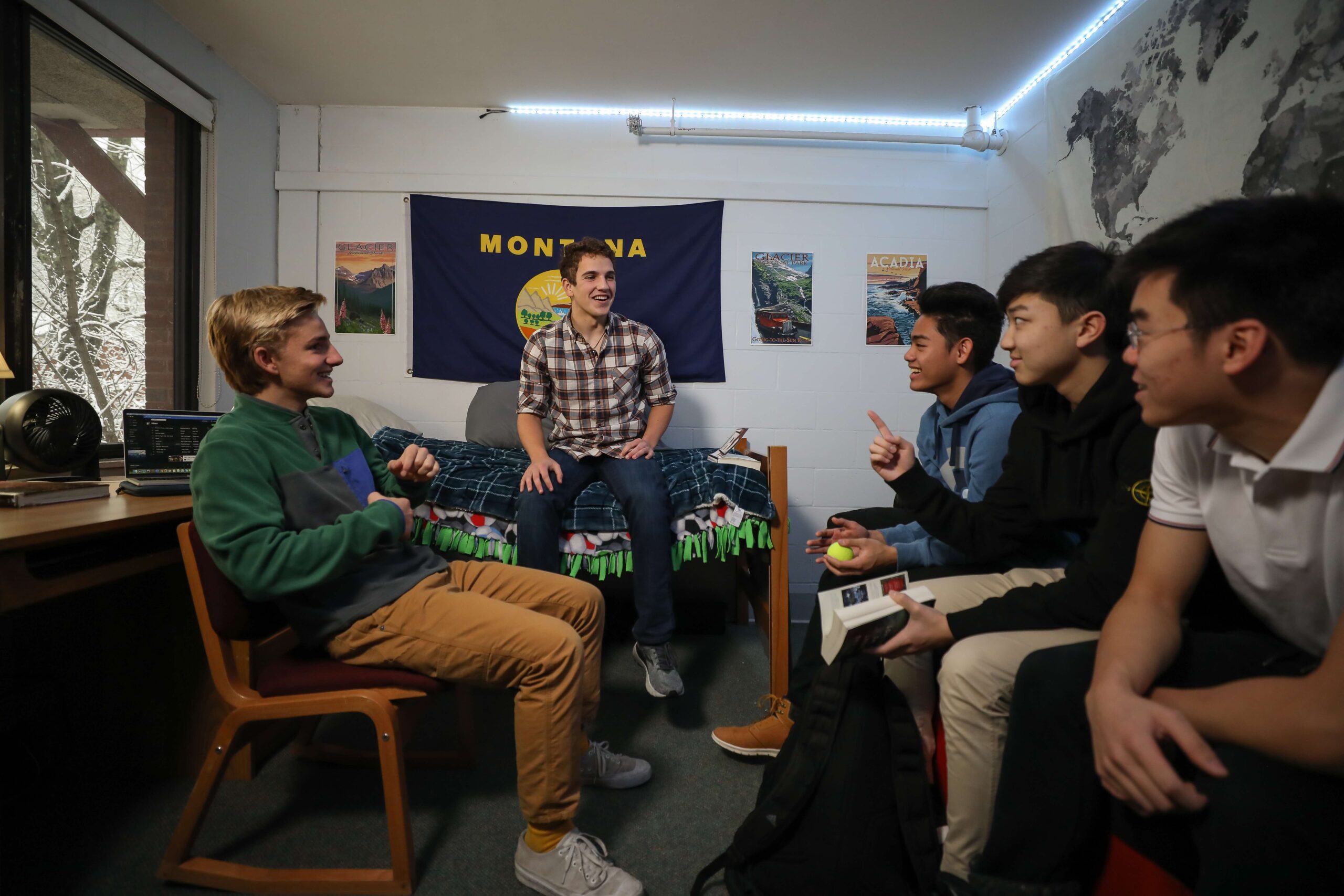 Group of boys sit in a dorm room