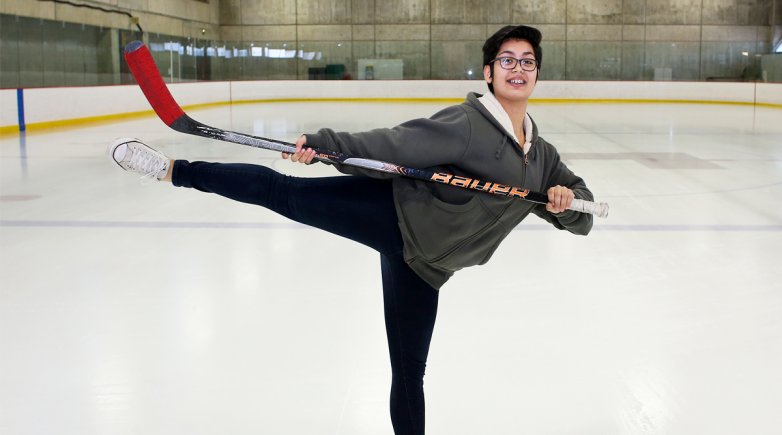 Fiona in a ballet pose with hockey stick.