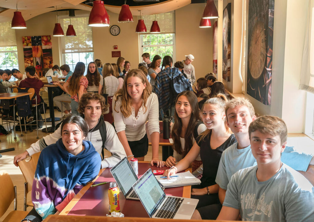 Group of students sit at a Grill table.