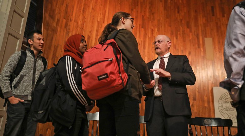 Exeter alumnus Michael Shafer talks with students on Assembly Hall stage.