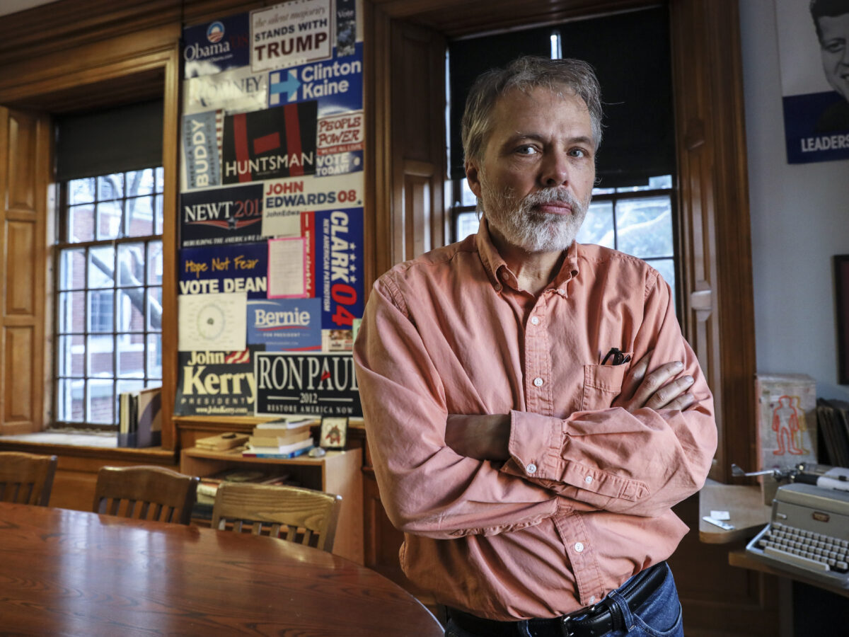 Bill Jordan stands in classroom next to Harkness table.