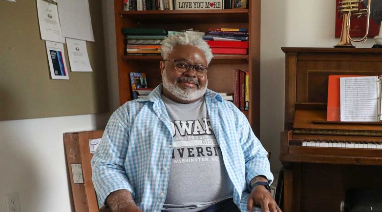 A smiling man sitting in a chair