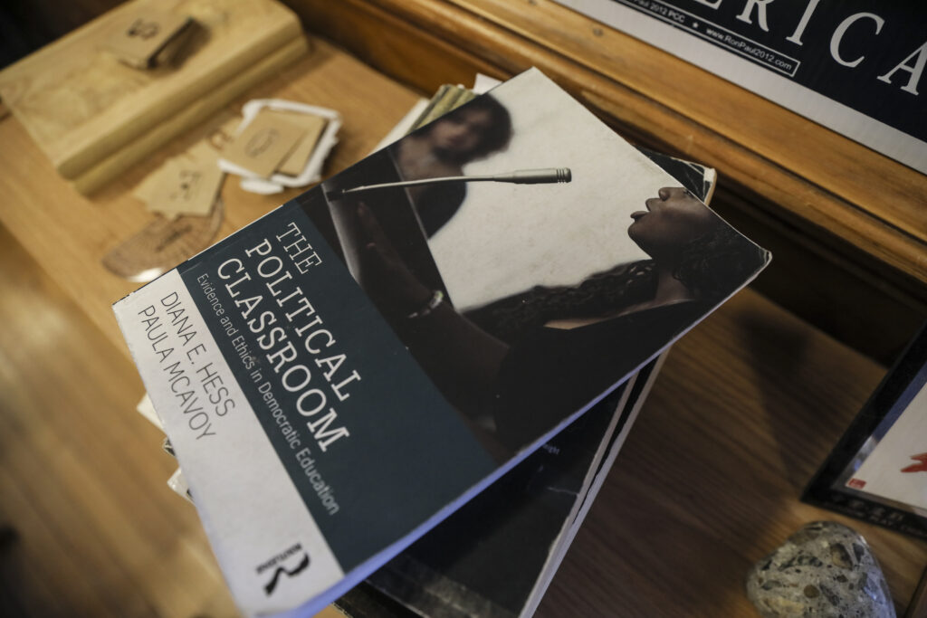 The Political Classroom book stacked on a desk.