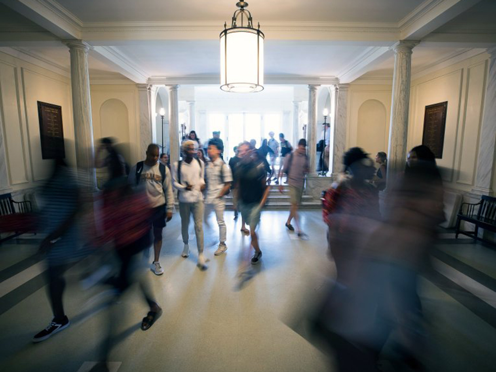 students walk through assembly hall lobby