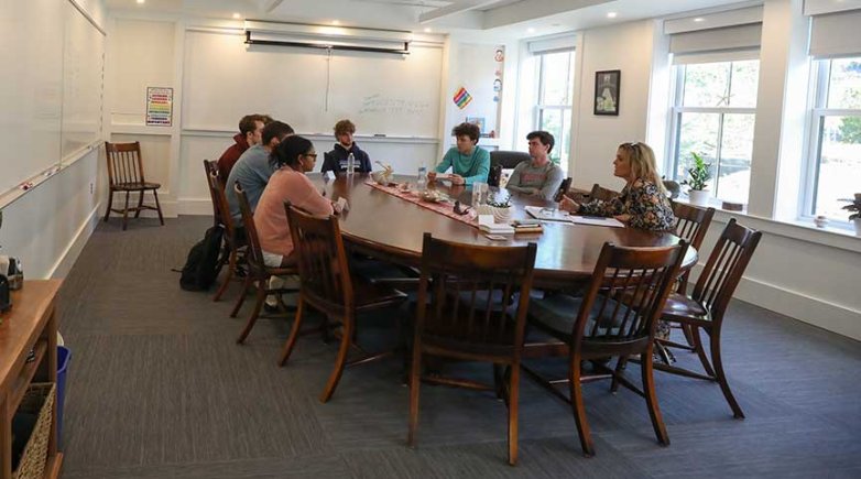 A group of people around a Harkness table.