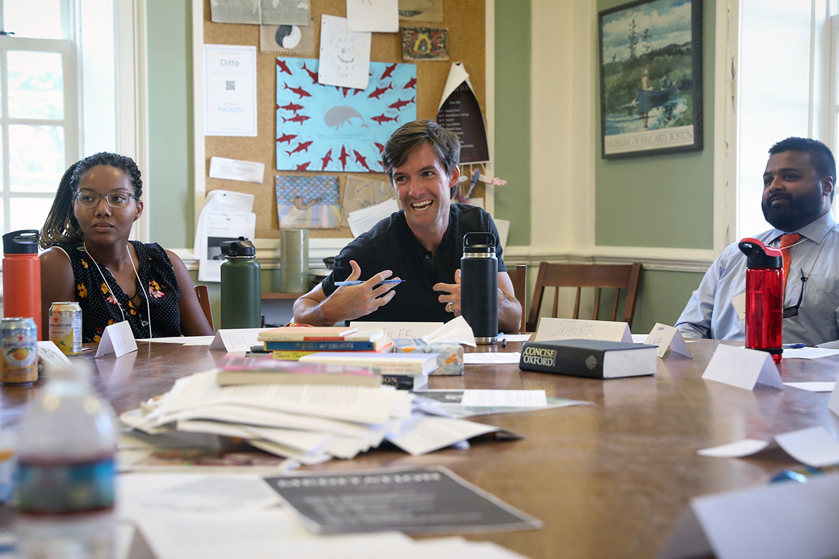 English Instructor Tyler Caldwell (center) facilitates a Harkness discussion for new faculty. 