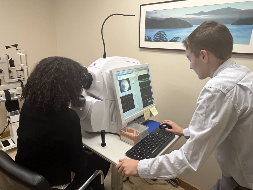 Student stands at computer during eye exam