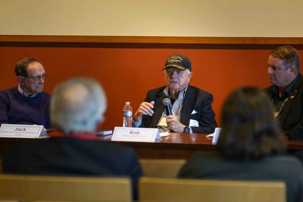 Panel speaker holds microphone.