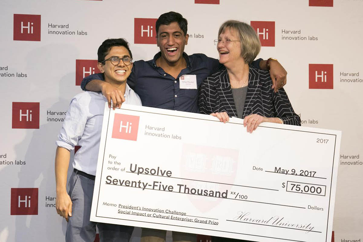 Milton Syed '14 and Rohan Pavuluri '14 accept a prize grant check from Harvard President Drew Faust.