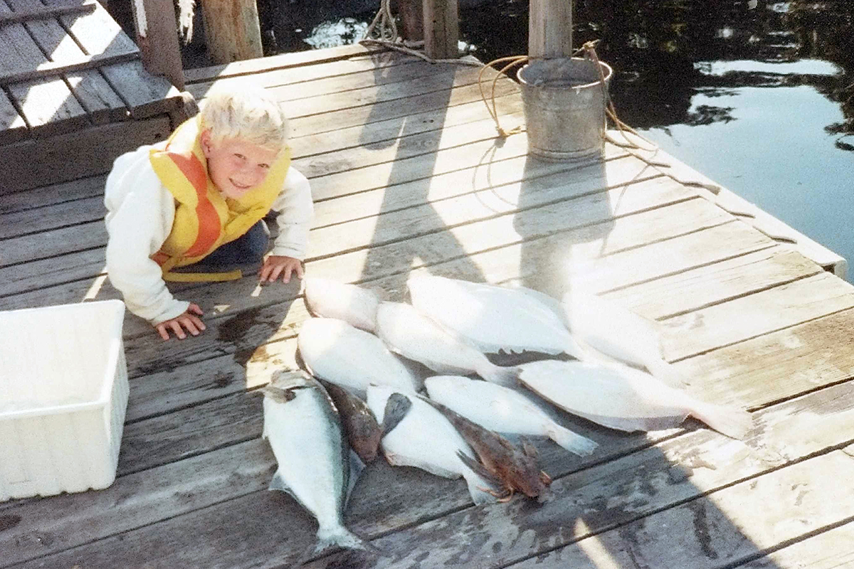 Stein as a young boy proudly showing off fish he helped catch. 