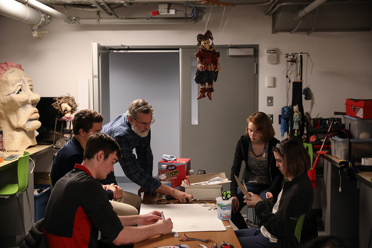 Rob Richards working with students in puppetry class.