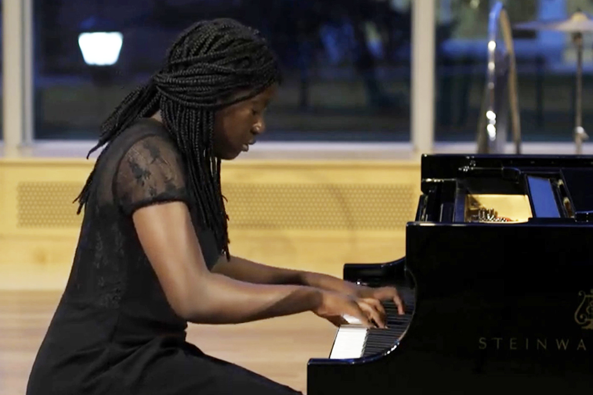 Exeter student Kiesse Nanor performing a song on the piano