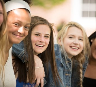 Five Exeter students smiling at the camera