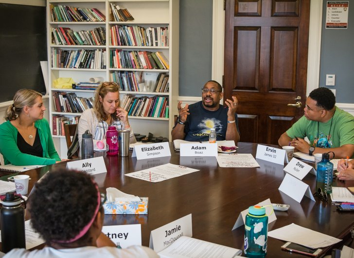 Educators hold a discussion around the Harkness table during the 2018 Exeter Harkness Institute.