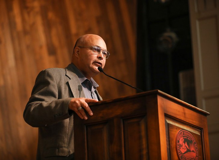 A speaker on Assembly Hall stage.