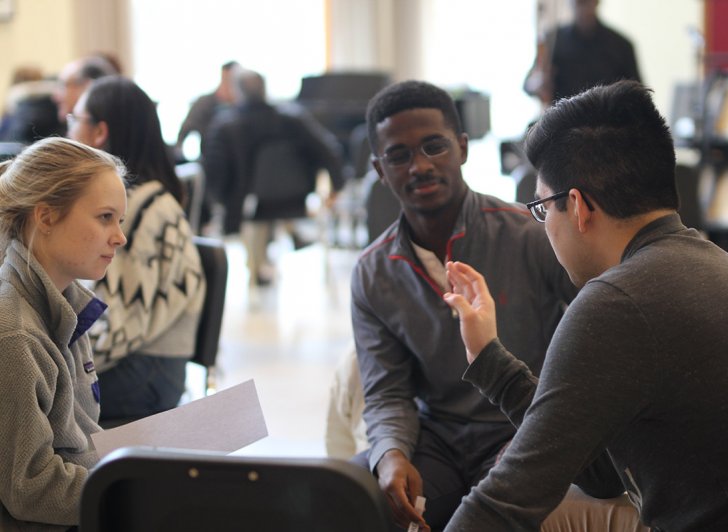 Students gather for discussion during David France's workshop on arts-based social change.