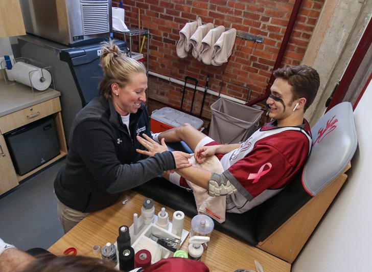 An athletic trainer helping an Exeter athlete in the Bravo Room