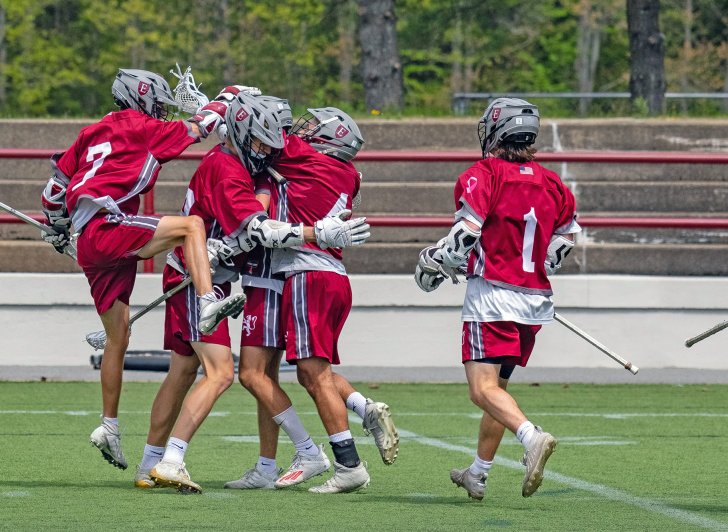 Exeter boys lacrosse team celebrating a goal