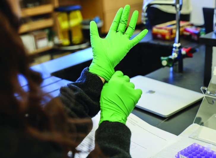 Gloved hand in science lab