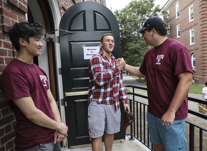 Exeter students greet each other outside of Wentworth Hall