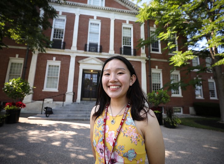Exeter student Angela Zhang  in the front of the Academy Building 