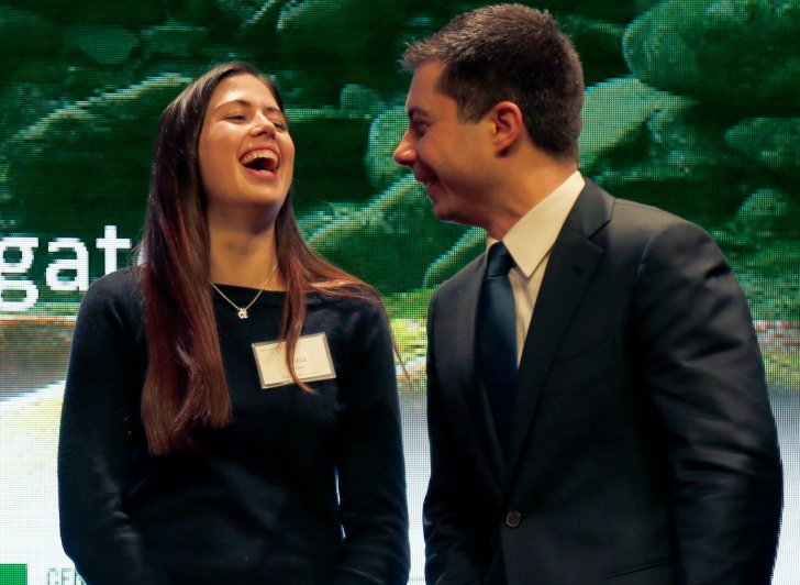 Exeter student laughing as she talks to presidential hopeful Pete Buttigieg.