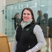 Coach Sarah Odell standing in front of squash courts at Exeter