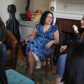 Jennifer Marx Asch in her dorm living room surrounded by students. 