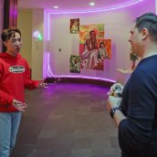 Justin Li and M. Sharkey discuss Li's artwork in the foyer of the Lamont Gallery.