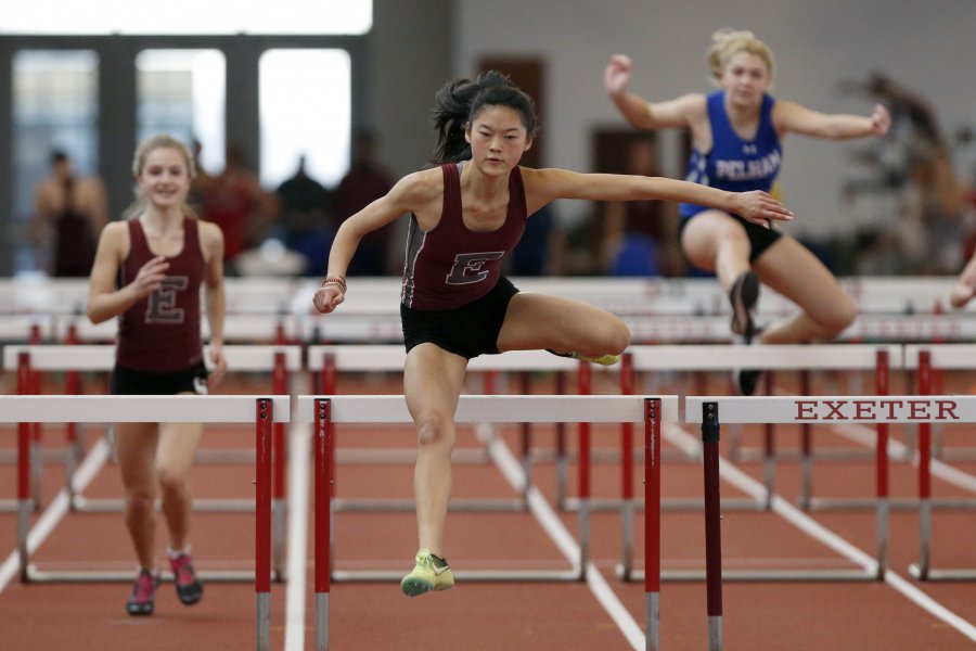 Evie Houston running hurdles.