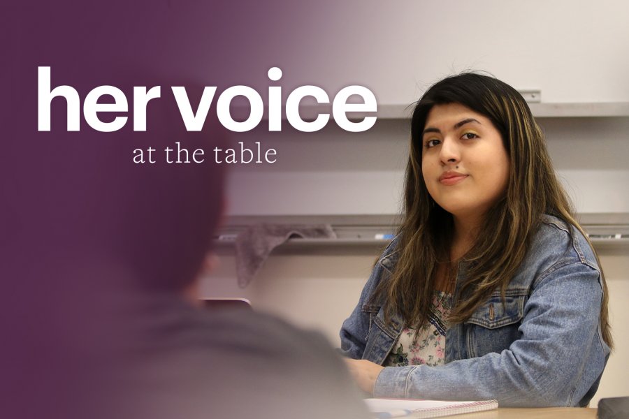 girl at a Harkness table looking at the camera