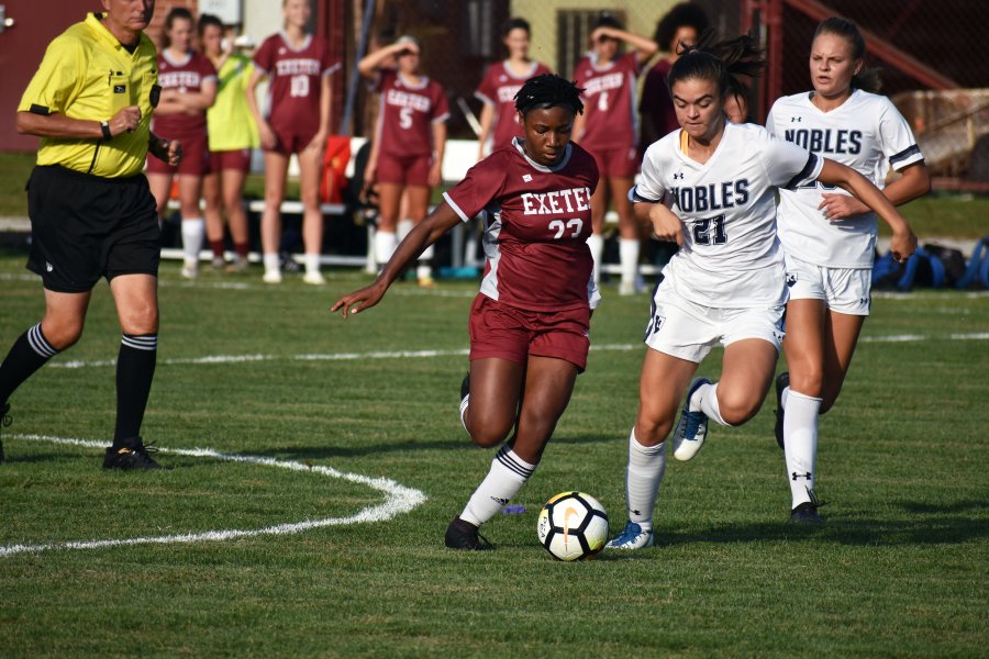 Exeter's Kaylee Bennett '22 fights with a Noble and Greenough player for possession during the 2019 season opener. 