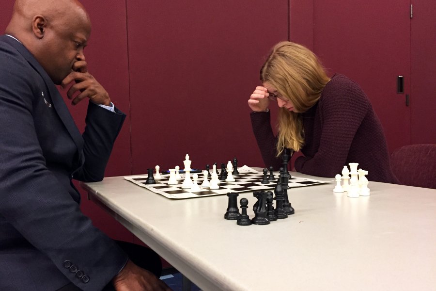 Chess Grandmaster Maurice Ashley (left) and Katya Davis '20 study the chess board in the last math of a 10-board simultaneous competition Thursday night, Jan. 8, 2020.