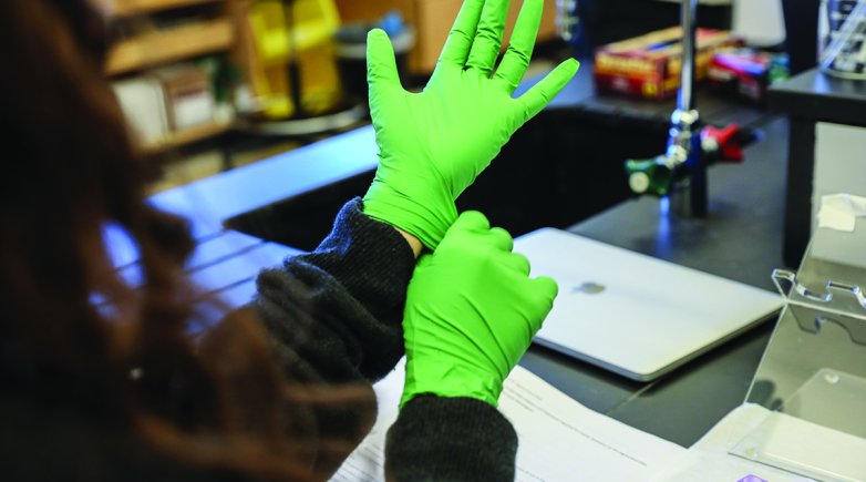 Gloved hand in science lab