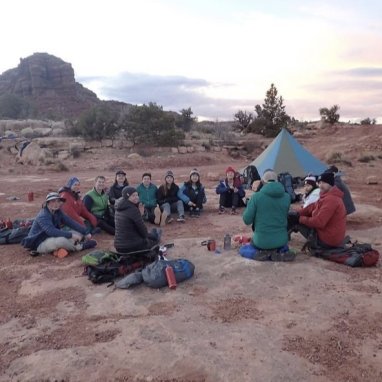 students sitting together in a dessert terrain