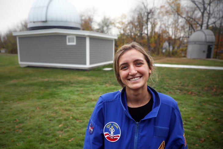 Ursula Wise standing in front of Grainger Observatory at Phillips Exeter Academy