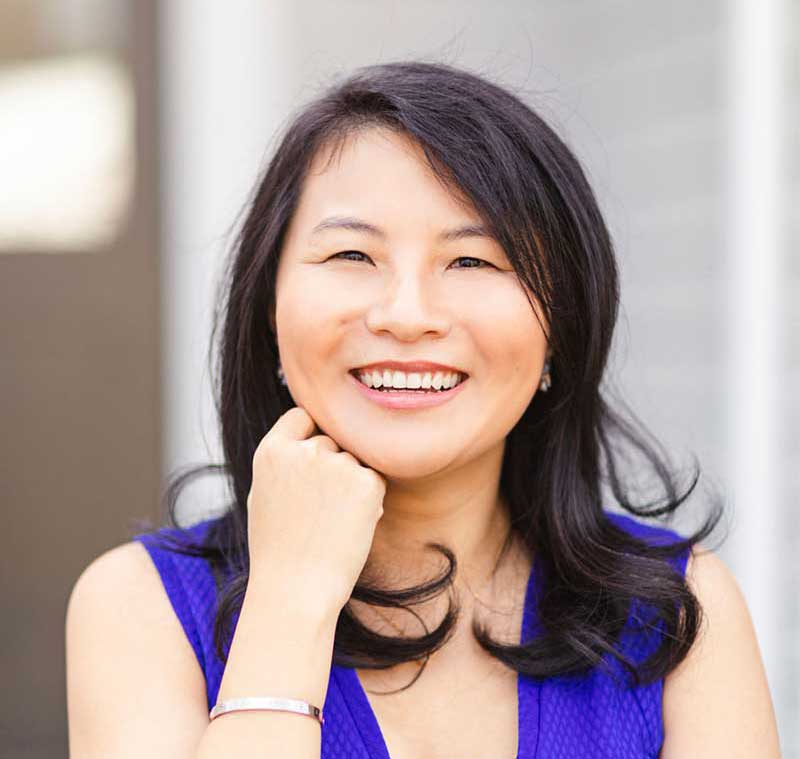 Profile photo of smiling woman in blue