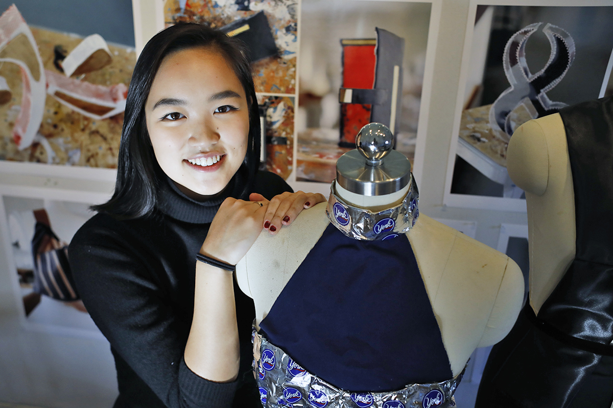 Ivy Tran with dresses she designed and made