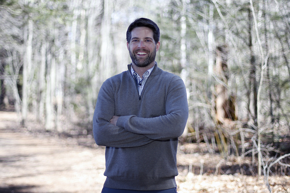 Exeter's Manager of Sustainability Warren Biggins at trailhead of Exeters trail network