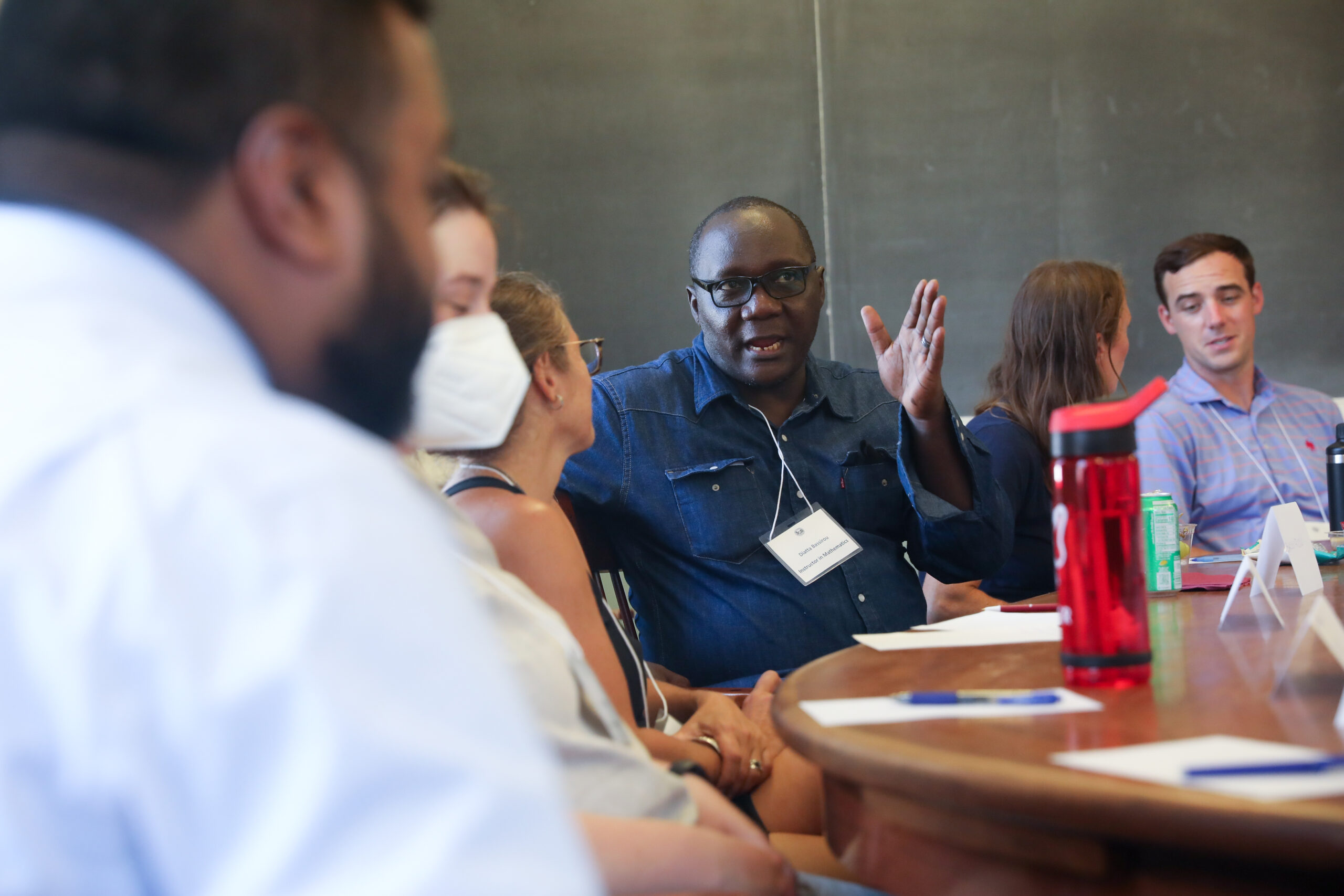 Bassirou Diatta, a new instructor in math, makes a point during a Harkness training class. 