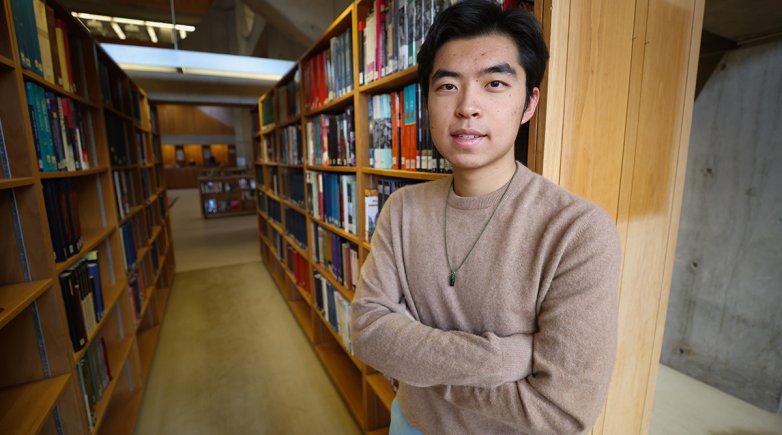 Andrew Yuan '24 standing in Class of 1945 Library