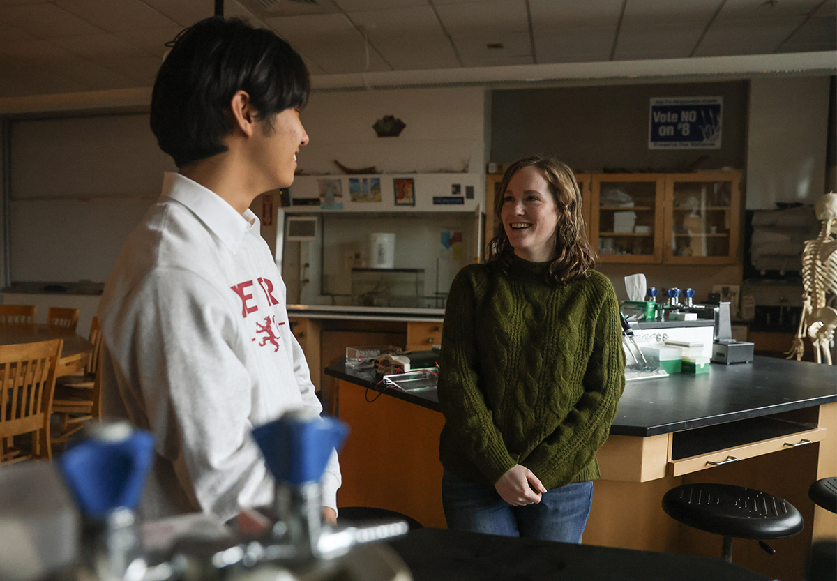 Aden Lee talks with teacher Summer Morrill in science classroom